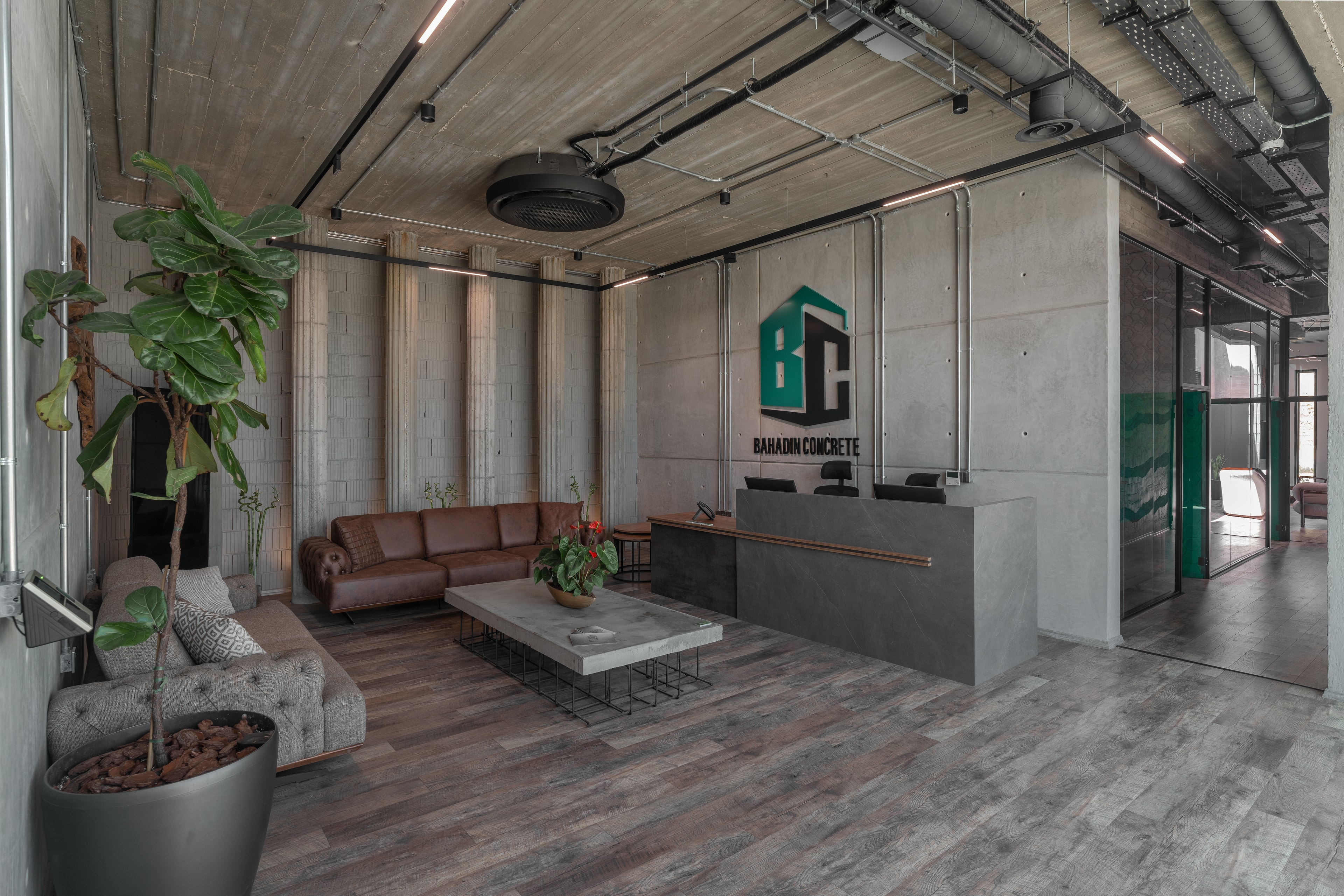 The lobby of the Bahadin Concrete head office: leather sofas, concrete walls and the company sign