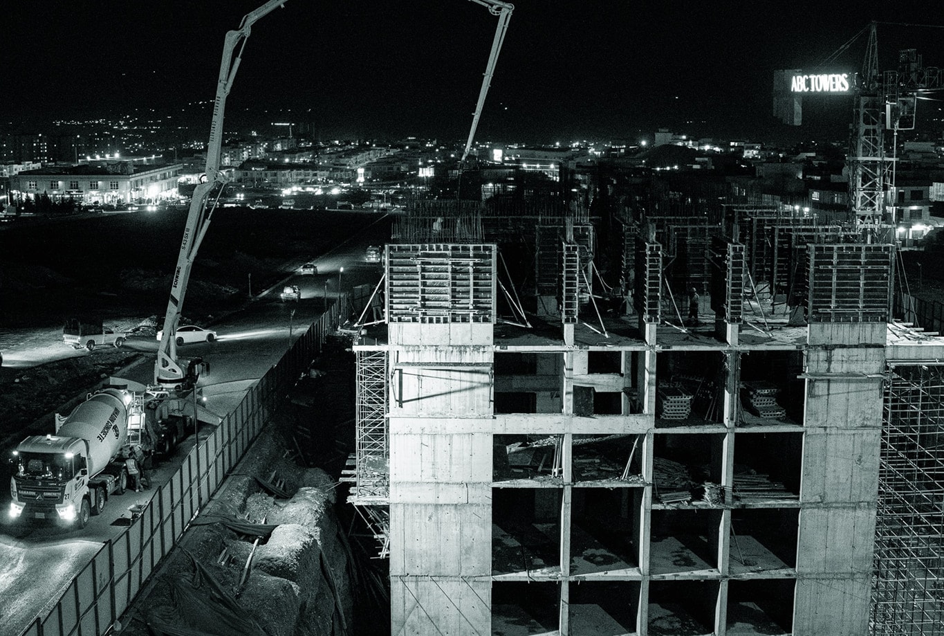 ABC Tower under construction at night, concrete pumps at work