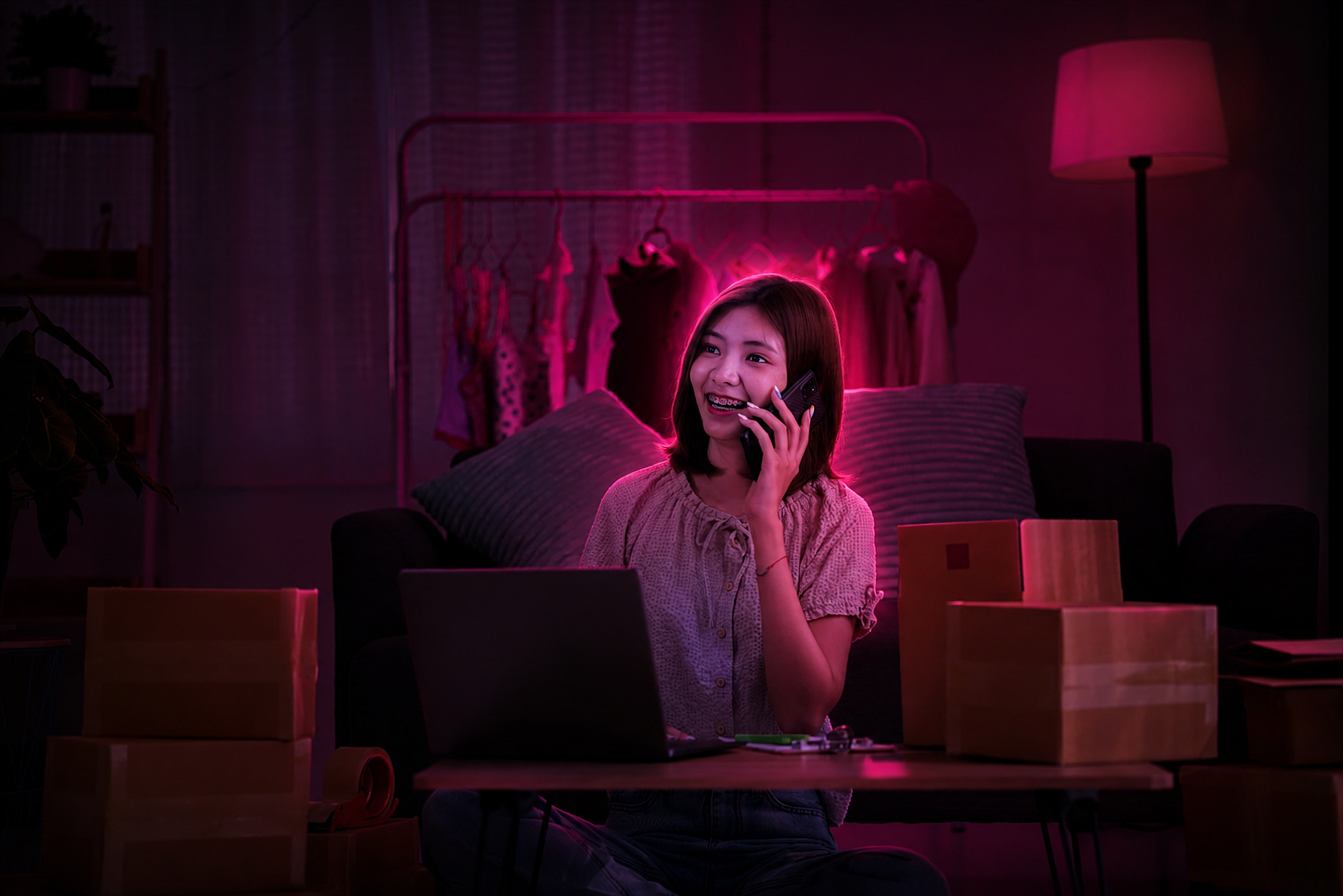An online seller taking an order by phone among packed boxes